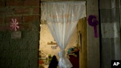 A curtain hangs in the doorway of what was the bedroom of Jhonny Godoy in La Vega slum of Caracas, Venezuela, Feb. 19, 2019. According to his family, two days after proclaiming his opposition to President Nicolas Maduro on Twitter, special police agents killed the 29-year-old.