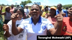 FILE: Zimbabwean war veterans who had gathered to demonstrate against a faction within the ruling Zanu pf party, reportedly led by the First Lady Grace Mugabe, vent their anger after they were dispersed by police using tear gas and water cannons in Harare, Thursday, Feb. 18, 2016. Mugabe was instrumental in the ouster of Zimbabwes first deputy President Joice Mujuru in 2014. (AP Photo/Tsvangirayi Mukwazhi)