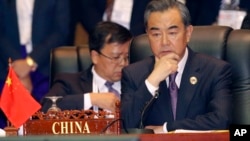 FILE - China's Foreign Minister Wang Yi, attends the 23rd ASEAN regional retreat meeting in Vientiane, Laos, July 26, 2016. Wang says he will strive to boost cooperation with the U.S. but foresaw "new, complicated and uncertain factors affecting bilateral relations'' under the Trump administration.