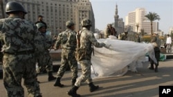 Egyptian Army soldiers remove tents of protesters from Tahrir Square in downtown Cairo, Egypt, Feb 13, 2011