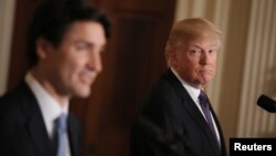 FILE - U.S. President Donald Trump, right, listens to Canadian Prime Minister Justin Trudeau during a joint news conference at the White House in Washington, Feb. 13, 2017. 