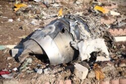 FILE - Debris from a Ukraine International Airlines plane that crashed after taking off from Iran's Imam Khomeini airport, is seen on the outskirts of Tehran, Iran, Jan. 8, 2020.