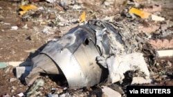 FILE - Debris of a plane belonging to Ukraine International Airlines, that crashed after taking off from Iran's Imam Khomeini airport, is seen on the outskirts of Tehran, Iran, Jan. 8, 2020. 