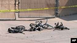 Damaged bikes can be seen in Show Low, Ariz., where a driver in a pickup truck plowed into bicyclists competing in a community road race, June 19, 2021. (White Mountain Independent photo)