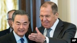 Russian Foreign Minister Sergey Lavrov, right, and China's Defense Minister Wei Fenghe enter a hall during their meeting in Moscow, Russia, April 5, 2018. 