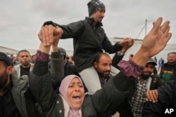 Freed Palestinian prisoners are greeted by a crowd as they arrive in the Gaza Strip after being released from an Israeli prison following a ceasefire agreement between Hamas and Israel in Khan Younis, southern Gaza Strip, on Feb. 8, 2025.