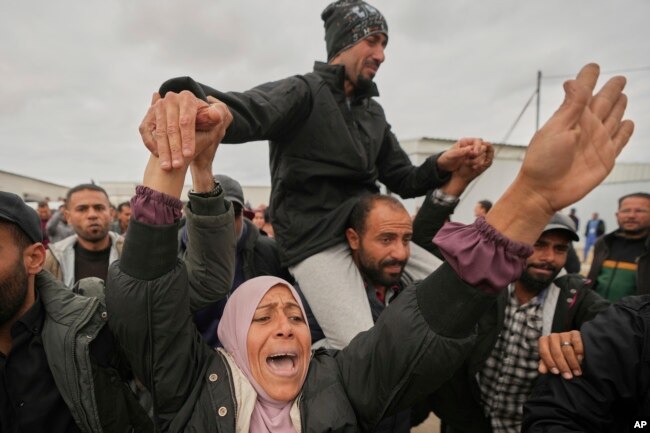 Freed Palestinian prisoners are greeted by a crowd as they arrive in the Gaza Strip after being released from an Israeli prison following a ceasefire agreement between Hamas and Israel in Khan Younis, southern Gaza Strip, on Feb. 8, 2025.