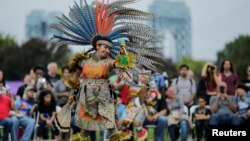 A reveler performs during a "pow-wow" celebrating the Indigenous Peoples' Day Festival in Randalls Island, in New York, Oct. 8, 2017. 