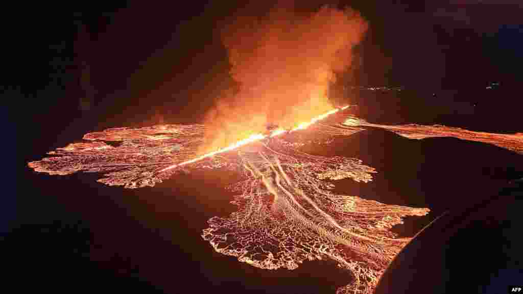 Handout picture released by the Public Defense Department of the State Police Commissioner in Iceland shows lava and smoke erupting from a volcano near Grindavik on the Icelandic peninsula of Reykjanes.