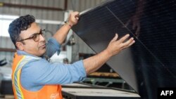 We Recycle Solar Chief Executive Officer Adam Saghei shows damaged solar pannels to be recycled at the We Recycle Solar plant in Yuma, Arizona on December 6, 2023.