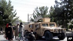 Taliban fighters guard outside the airport in Kabul, Afghanistan, Aug. 27, 2021, a day after a deadly attack.