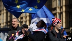 Anti-Brexit remain in the European Union supporters shout slogans during a protest outside the Houses of Parliament in London, March 14, 2019. 