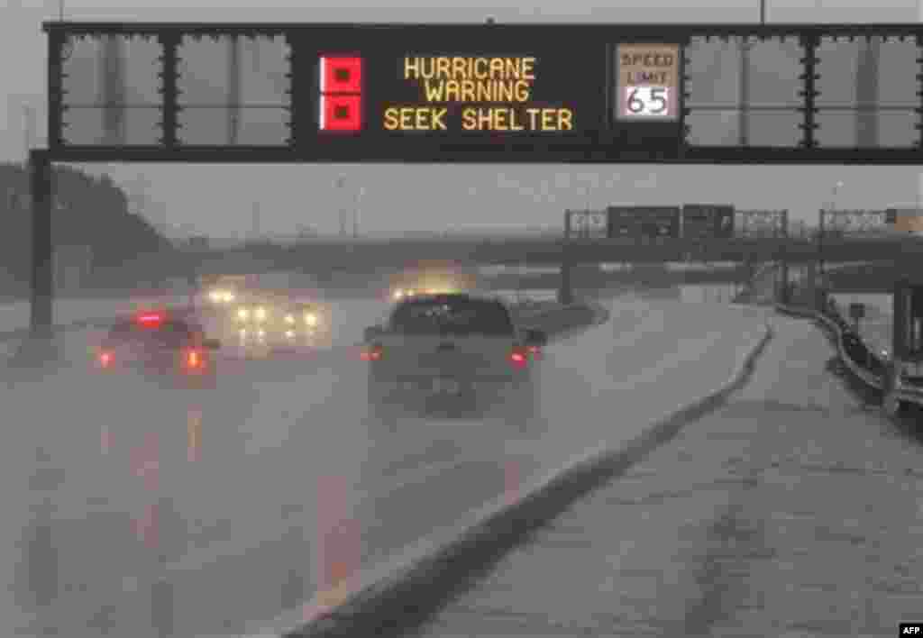 A sign warns commuters on the northbound side of the New Jersey Turnpike of the incoming Hurricane Irene as the state braced itself for the storm, Saturday, Aug. 27, 2011, Elizabeth, N.J. (AP Photo/Julio Cortez)