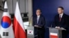 South Korean Minister of Foreign Affairs Cho Tae-yul, left, and Poland's Foreign Minister Radek Sikorski give a statement following a meeting at the Foreign Ministry in Warsaw, Poland, March 5, 2025.