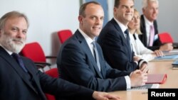 Britain's Secretary of State for Exiting the European Union Dominic Raab (C) and Britain's ambassador to the EU Tim Barrow (L) attend a meeting with EU's chief Brexit negotiator Michel Barnier in Brussels, Belgium, July 19, 2018.