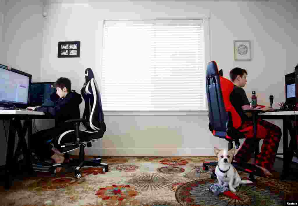 Foxton Harding, left and Adison Pucci, both 12, who attend Northshore Middle School, which has moved to online schooling for two weeks due to coronavirus concerns, work on school assignments at their home in Bothell, Washington, March 11, 2020.