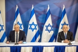 Israeli Prime Minister Benjamin Netanyahu issues a statement at the Israeli Defense Ministry in Tel Aviv, Israel with the Alternate PM and Defence Minister Benny Gantz, July 27 2020.