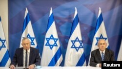 Israeli Prime Minister Benjamin Netanyahu, right, listens at the Israeli Defense Ministry in Tel Aviv, Israel as Alternate PM and Defense Minister Benny Gantz, delivers a statement on July 27 2020.