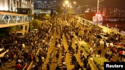 Para pedemo anti-pemerintah memblokir sebuah jalan dekat Hong Kong Polytechnic University (PolyU) di Hong Kong, China, 18 November 2019. (Foto: Reuters)