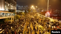 Anti-government demonstrators block a road near the Hong Kong Polytechnic University (PolyU) in Hong Kong, China, Nov. 18, 2019. 