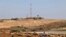FILE - A picture take on Dec. 15, 2021 shows farmers working in their fields near the border with Israel and the Hamas-controlled Gaza Strip enclave near the town of Beit Lahia