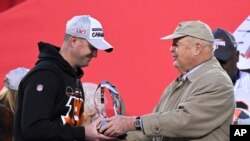 Cincinnati Bengals owner Mike Brown hands the Lamar Hunt trophy to head coach Zac Taylor during the second half of the NFL AFC Championship football game, Jan. 30, 2022 in Kansas City, Mo.