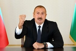 In this photo provided by the Azerbaijan's Presidential Press Office provided on Sept. 27, 2020, Azerbaijani President Ilham Aliyev gestures as he addresses the nation in Baku, Azerbaijan.