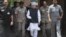 Indian PM Manmohan Singh, center, arrives to make a statement to the media after he was shouted down by opposition politicians in the lower house of Parliament, in New Delhi, India, August 27, 2012.