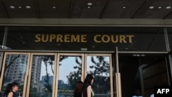 FILE - People enter the Supreme Court building in Singapore, Nov. 13, 2019.