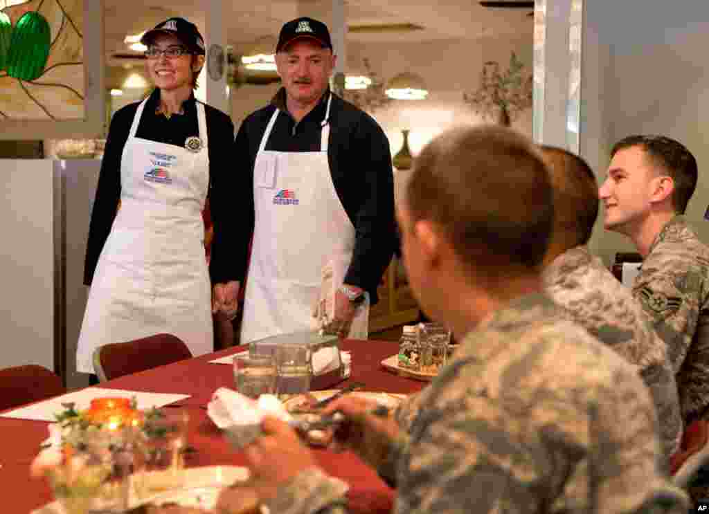 Rep. Giffords, D-Ariz., and her husband, retired Capt. Mark Kelly, meet both active and retired airmen after serving a Thanksgiving meal to troops at Davis-Monthan Air Force Base, Thursday, Nov. 24, 2011, in Tucson, Ariz. (AP)