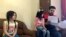 Syrian refugee Mahmoud Mansour, sitting with his daughters Sahar, 5, and Ruba, 11, holds documents for his U.S. resettlement application at his rented apartment in Amman, Jordan, Wednesday, June 27, 2018.