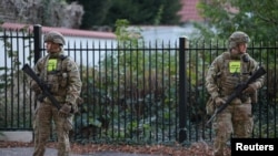 Security personnel keep watch during the investigation of two blasts near the Israeli Embassy in Copenhagen, Denmark, on Oct. 2, 2024. Authorities arrested two Swedish teenagers on Oct. 3 in connection with the explosions. (Ritzau Scanpix via Reuters)