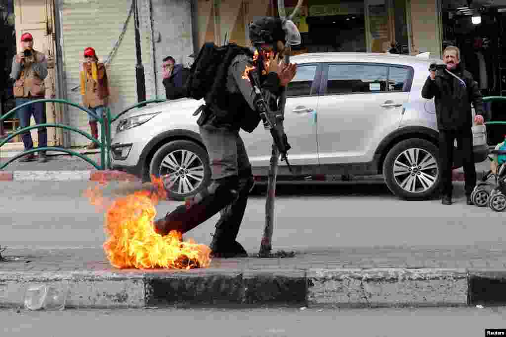 An Israeli border policeman is on fire as he is hit with a molotov cocktail thrown by Palestinian demonstrators during a protest against the U.S. President Donald Trump&#39;s Middle East peace plan, in Hebron in the Israeli-occupied West Bank, Feb. 3, 2020.