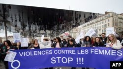 Women hold a banner reading "Stop violences against women" during a protest march to condemn violence against women, on Nov. 23, 2019 in Marseille, southern France. 