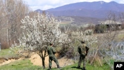 FILE - Georgian border guards patrol a border with Georgia's breakaway region of South Ossetia, near the village of Khurvaleti, Georgia, April 8, 2017.