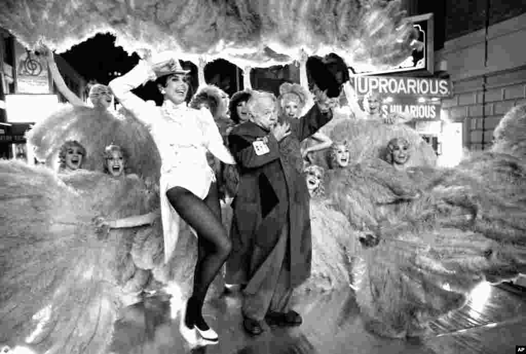 Ann Miller and Mickey Rooney are surrounded by Sugar Babies from the Broadway musical comedy revue of the same name as they film a portion for the newest &quot;I Love New York&quot; commercial, New York City, Oct. 31, 1980.&nbsp;