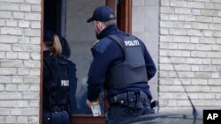 Danish police are seen entering an apartment as part of an operation that resulted in the arrest of four suspected Islamic State recruits, in Tingbjerg, Copenhagen, Denmark, Apr. 7, 2016.