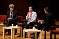 He Jiankui, a Chinese researcher, center, speaks during the Human Genome Editing Conference in Hong Kong, Wednesday, Nov. 28, 2018. He made his first public comments about his claim to have helped make the world's first gene-edited babies.