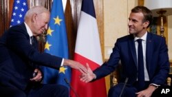 U.S. President Joe Biden, left, shakes hands with French President Emmanuel Macron during a meeting at La Villa Bonaparte in Rome, Italy, Oct. 29, 2021.