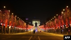 FILE - This picture shows the Champs Elysee avenue during the New Year's Eve as a 8:00 pm-6:00 am curfew is implemented in France to avoid a third wave of Covid-19 infections, in Paris, Jan. 1, 2020. 
