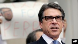 Texas Gov. Rick Perry talks to the media and supporters after he was booked at the Blackwell Thurman Criminal Justice Center, Aug. 19, 2014, in Austin, Texas. 