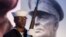 FILE - A Navy sailor and member of an honor guard stands in front of a photograph of Gen. Dwight D. Eisenhower during the groundbreaking at the site of the Dwight D. Eisenhower Memorial, in Washington, Nov. 2, 2017. 