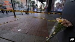 A bouquet of flowers leans at the intersection of Bourbon and Canal streets during the investigation of a pickup truck that rammed into a crowd of revelers early on New Year's Day in New Orleans, Louisiana, Jan. 1, 2025.