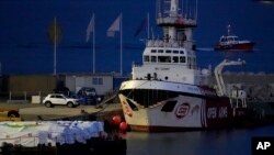 FILE—Aid packages are seen left, on a platform near to the docked ship belonging to the Open Arms aid group, as it prepares to ferry some 200 tons of rice and flour directly to Gaza, at the port in Larnaca, Cyprus, March 10, 2024.