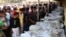 Bangladeshi people identify the bodies of their relatives died in a fire at a garment factory in the Savar neighborhood in Dhaka, Bangladesh, November 25, 2012.