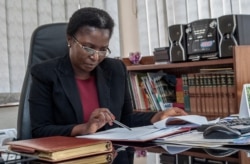 FILE - Malawi Ombudsman Martha Chizuma works at her desk before giving an interview with Agence France-Presse in her office in Lilongwe, Malawi, Sept. 9, 2019.
