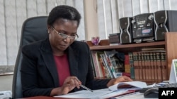 FILE - Malawi Ombudsman Martha Chizuma works at her desk before giving an interview with Agence France-Presse in her office in Lilongwe, Malawi, Sept. 9, 2019.