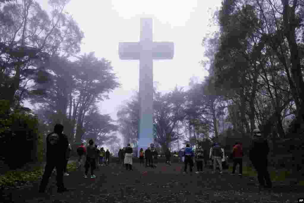 People gather at the Mount Davidson cross in San Francisco, California. Mount Davidson&#39;s annual Easter Sunrise Service was canceled for the city&#39;s shelter in place orders over coronavirus concerns.