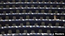 FILE - A member of the European Parliament attends a debate on the state of union, in Strasbourg, September 11, 2013. 