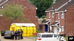 A police probe continues on Biddick Drive in the Keyham area of Plymouth, England, Aug. 13, 2021, a day after a gunman killed five people and then took his own life.